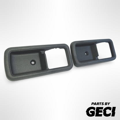 A pair of dark grey 3D printed door handle surrounds for Subaru Brumby/Brat/Leone models.